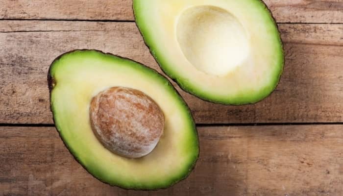 avocado with stone sliced in half